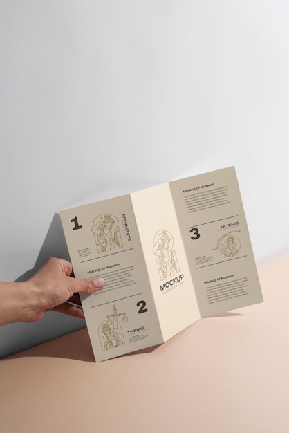 PSD trifold brochure mock-up held by person in hand