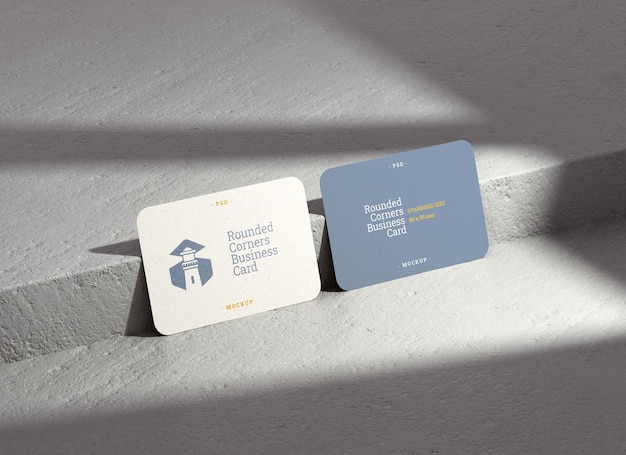 Two business card mockup with rounded corners and shadows on a concrete background for branding presentation in realistic 3D rendering