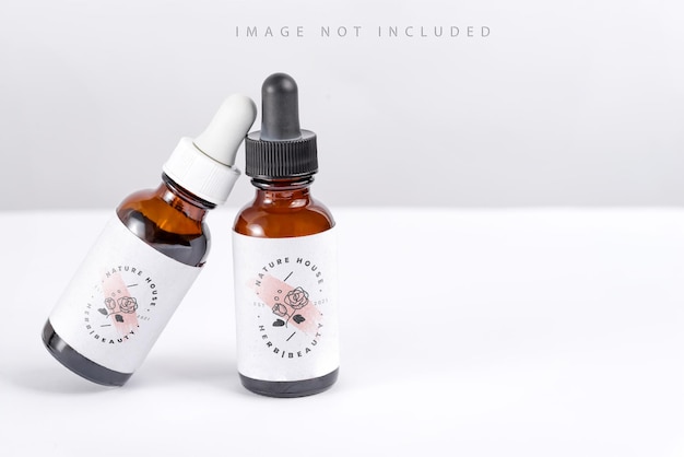 Two mockup bottles with pipettes on a white background