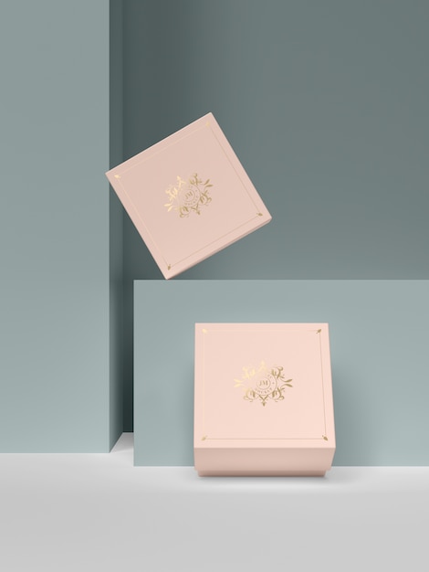 Two pink jewelry boxes with golden symbols