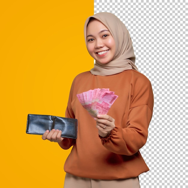 Uśmiechnięta młoda Azjatka w pomarańczowej koszuli trzymająca portfel i banknoty