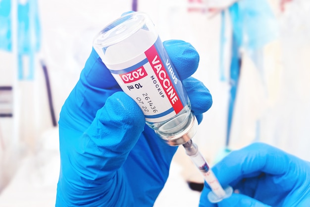 PSD vaccine bottle and syringe in doctor's hands mockup