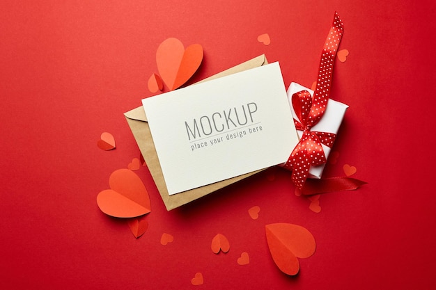 PSD valentine's day card mockup with envelope, gift box and red paper hearts