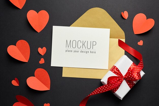 Valentines day card mockup with envelope, red hearts and gift box on black paper