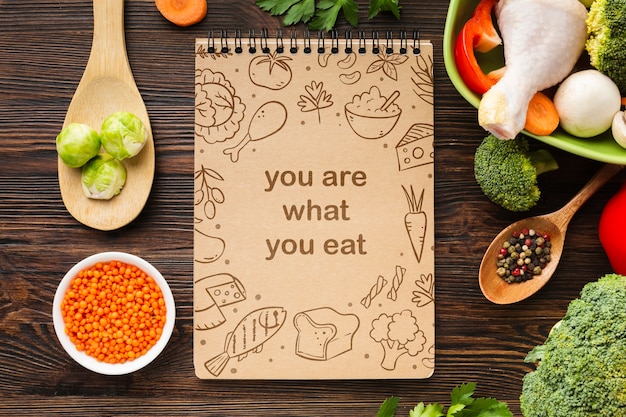 Vegetables on table beside notebook