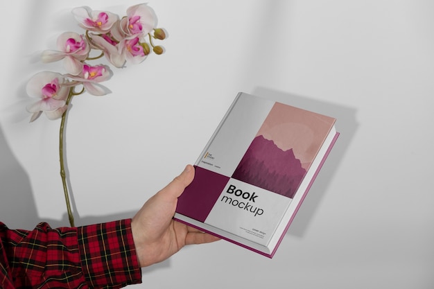 PSD view of hand holding book mock-up