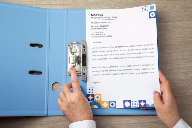 PSD view of human hands holding paper document mock-up