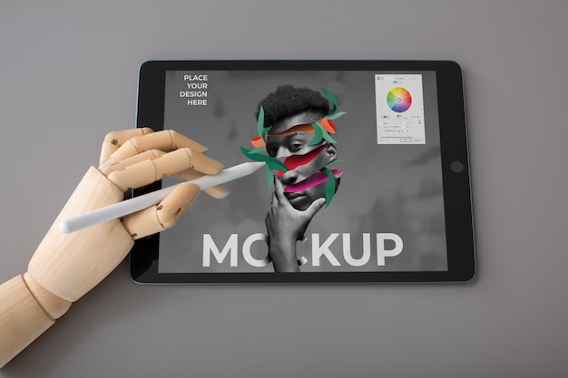 Above view model holding pencil and tablet mockup