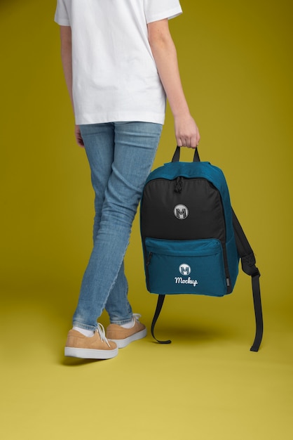 View of person holding backpack mock-up