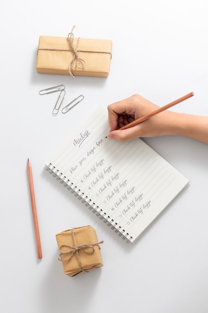 View of person writing on paper with pencil