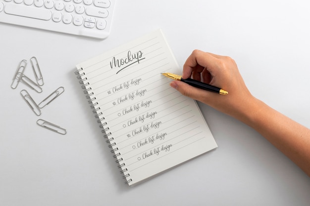 View of person writing on paper with pencil