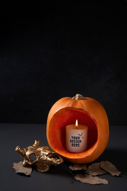 View of spooky halloween pumpkin with lit candle