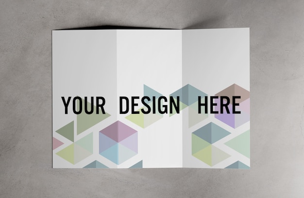 PSD view of a trifold brochure on cement table mockup