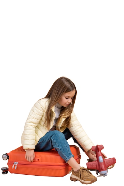 PSD view of young girl with luggage for traveling and toy plane