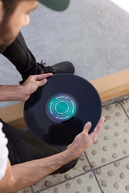 PSD vinyl record mockup held in hand