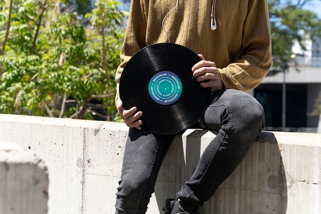 PSD vinyl record mockup held in hand