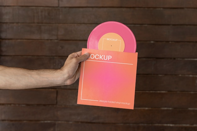 PSD vinyl record mockup held in hand