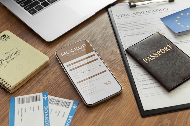 Visa application mock up in smartphone on table with passport and documents