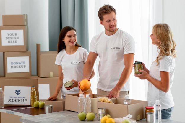 Volunteers preparing food in boxes for donation