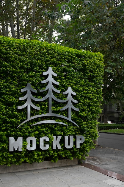 Wall logo mock-up design with vegetation background