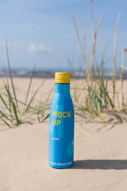 PSD water drop bottle mockup in nature