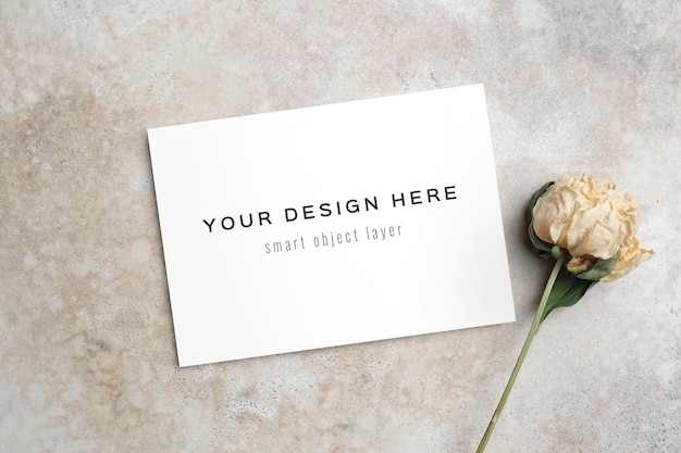 wedding invitation card mockup with dry flower on beige background