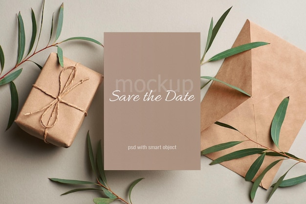 Wedding invitation card mockup with envelope, gift box and eucalyptus twigs