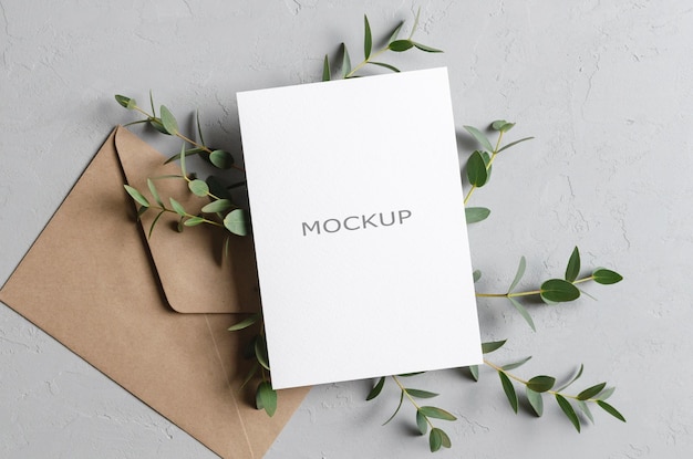 Wedding invitation card mockup with envelope and natural eucalyptus twigs