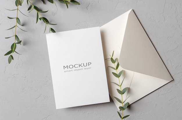Wedding invitation card mockup with eucalyptus twigs and envelope