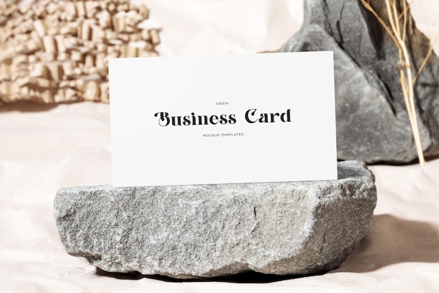 White business card mockup standing on stone surface