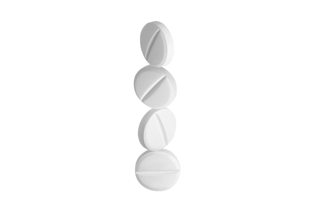White capsules pills or tablets standing vertically in a row on top of each other on isolated transparent background