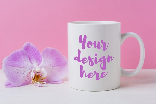 White coffee mug mockup with purple orchid