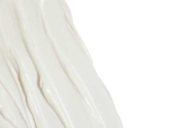 White cosmetic cream smeared on a blank background