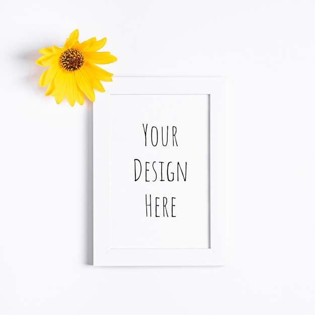 White empty picture frame mockup with yellow flower
