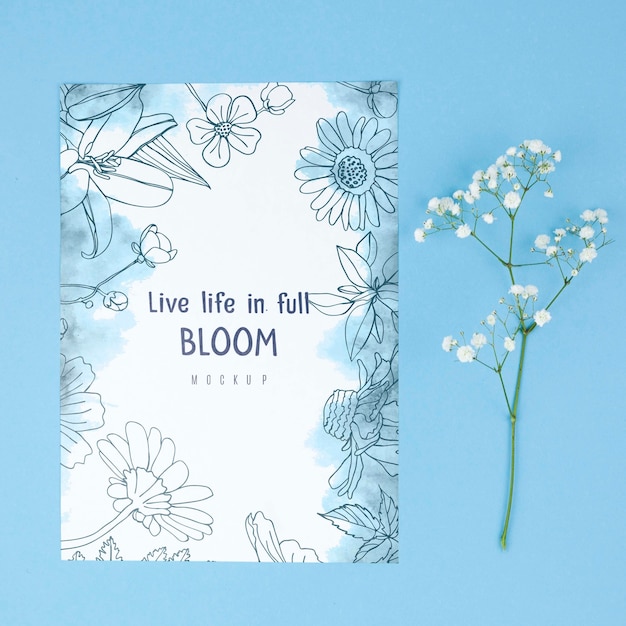 White flower placed next to card mockup