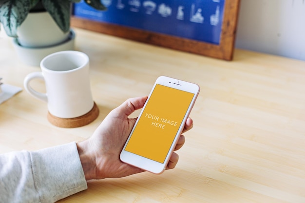 White Phone Screen Mockup Held in Hand at Home Office