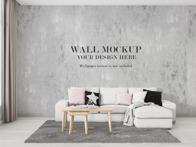 White sofa in front of mockup design wall