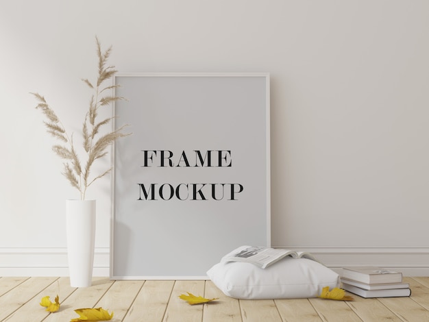 Witte fotolijst mockup naast droge plant en bladeren