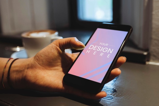 Woman in a cafe using a mobile phone mockup