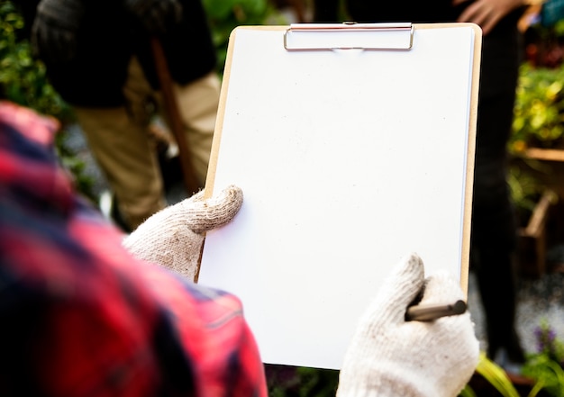 Woman checking list on clipboard for organic fresh agricultural product