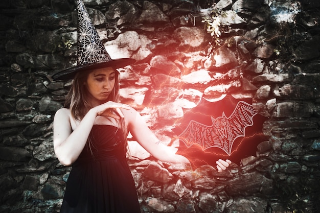 PSD woman dressed as a witch making a red light spell