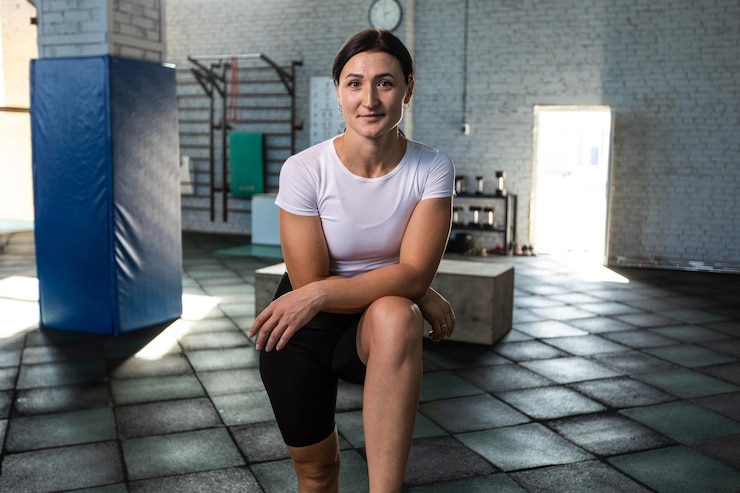 PSD woman in gym setting smiling and posing