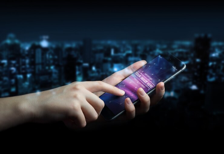 PSD woman hand holding modern smartphone in dark mockup