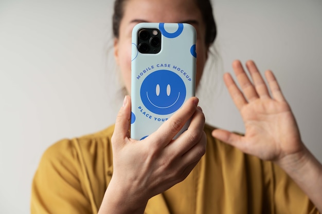 Woman hand holding smartphone mock-up indoors