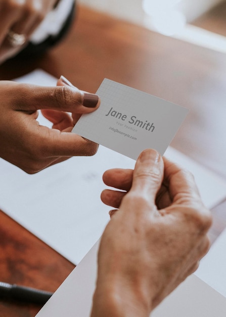 PSD woman handing a business card mockup