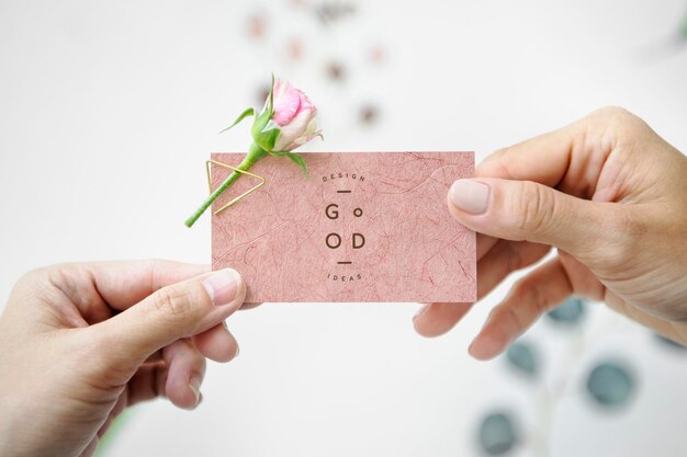 PSD woman handing a name card mockup