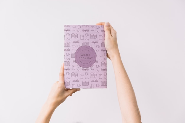 Woman holding book cover mockup