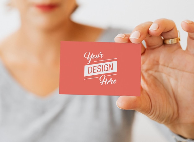 PSD a woman holding a business card mockup