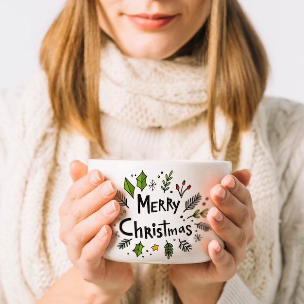 PSD woman holding cup mockup with christmas concept