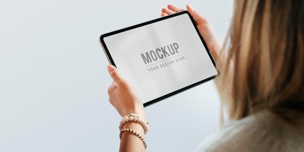 Woman holding a digital tablet mockup